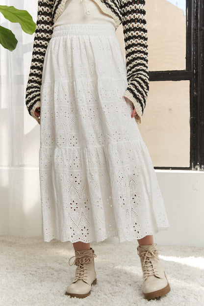 White ADORA elastic waistband tiered midi skirt by Trendsi, featuring flowing fabric and layered design.