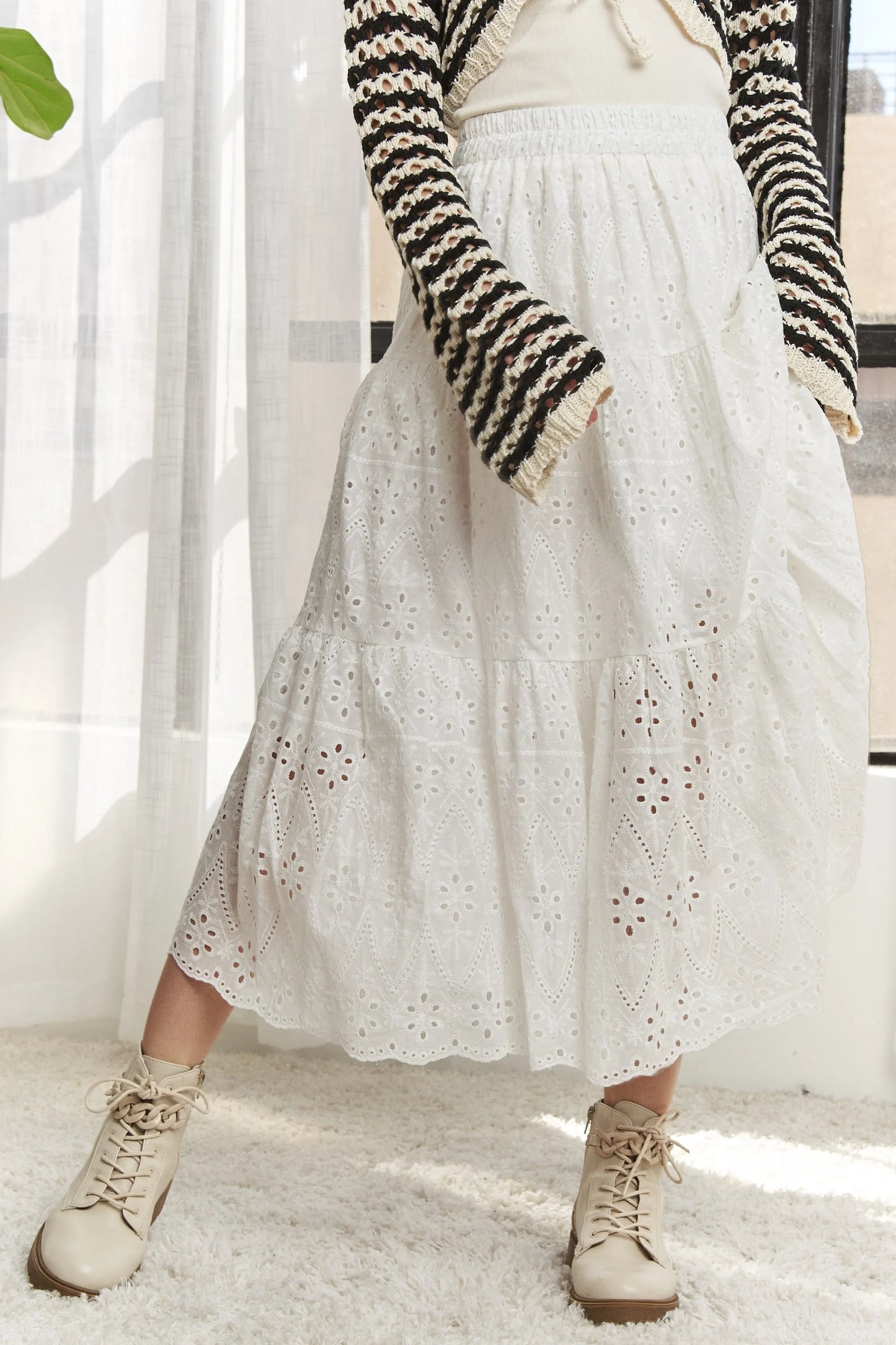 White ADORA tiered midi skirt with elastic waistband, flowing design, perfect for casual and dressy occasions.