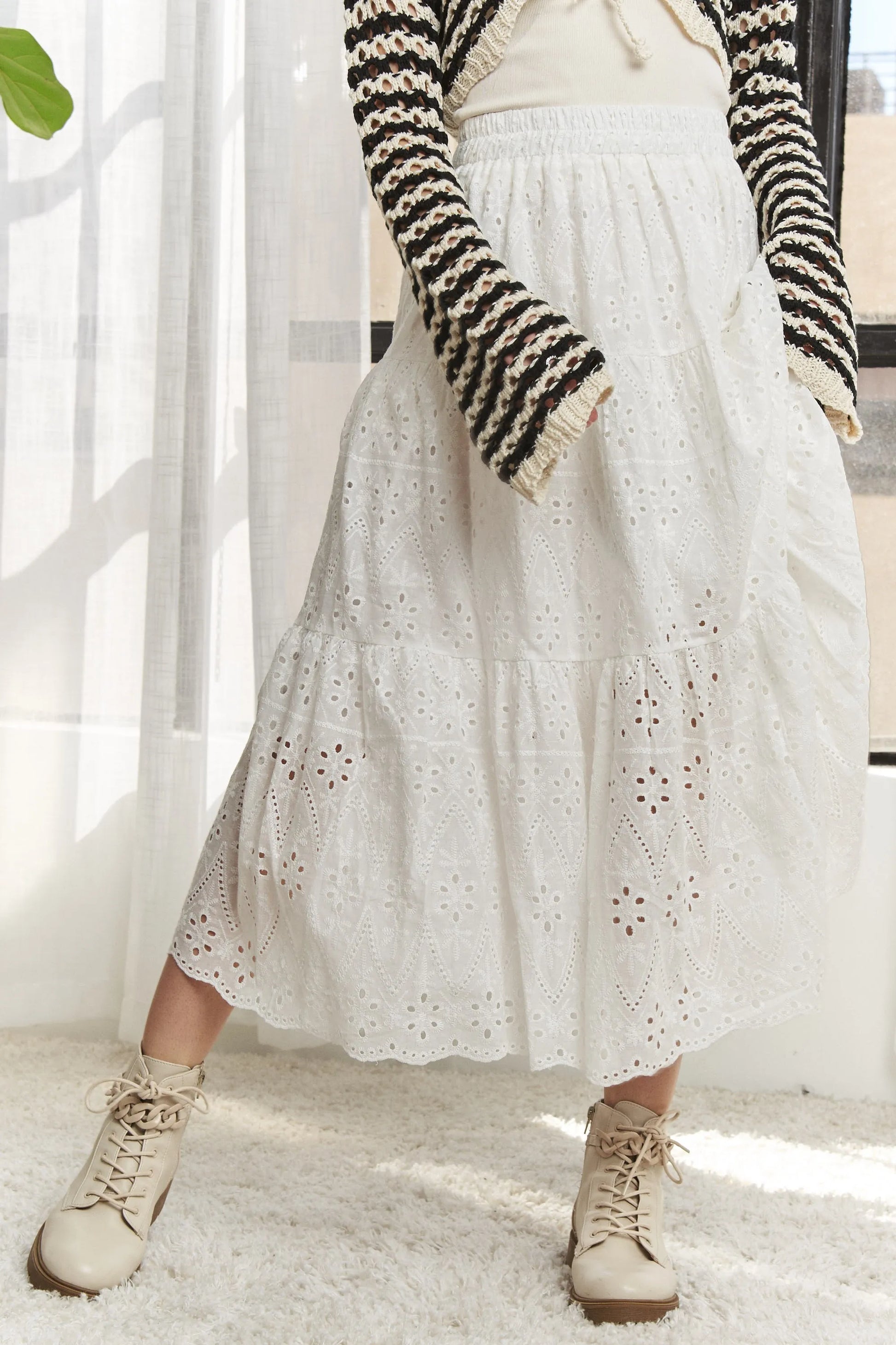 White ADORA tiered midi skirt with elastic waistband, flowing design, perfect for casual and dressy occasions.