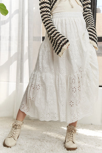 White ADORA tiered midi skirt with elastic waistband, flowing design, perfect for casual and dressy occasions.