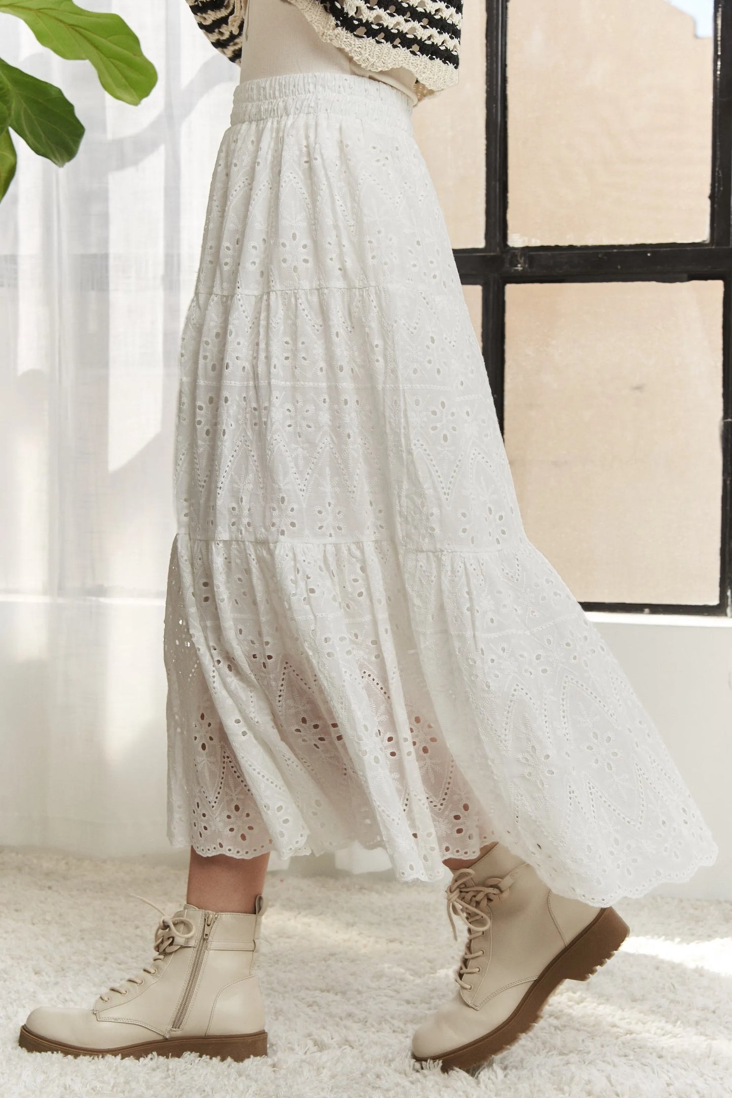 White ADORA elastic waistband tiered midi skirt by Trendsi, featuring flowy layered fabric and a comfortable high-waist design.