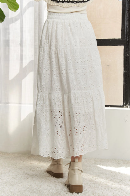 White ADORA elastic waistband tiered midi skirt by Trendsi, featuring a flowy, layered design and comfortable fit.