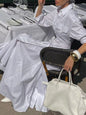 White button-front long sleeve maxi shirt dress by Trendsi, featuring a relaxed fit and classic collar, perfect for casual wear.