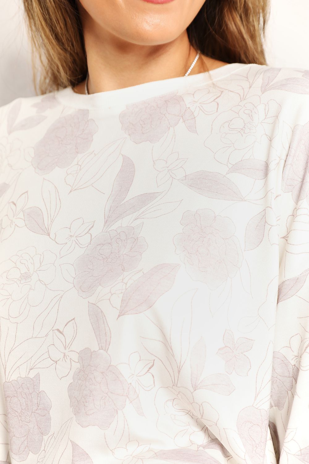 White floral long sleeve top and shorts loungewear set by Trendsi, casual and comfortable for relaxed wear.