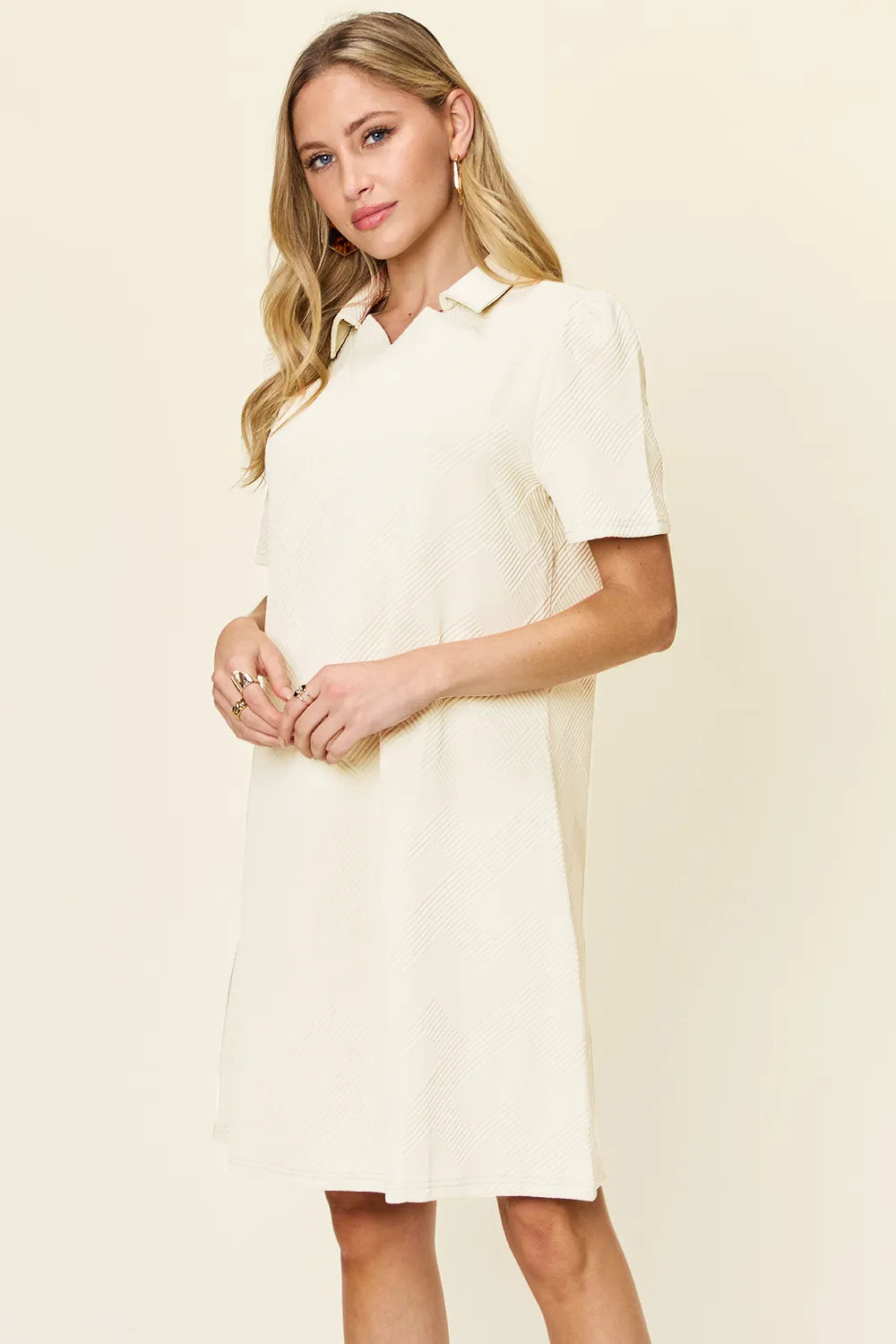 White double take full-size textured collared neck short sleeve dress by Trendsi, shown on a hanger.