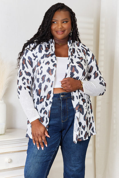 White leopard print long sleeve cardigan by Trendsi, featuring a cozy fit and stylish pattern.