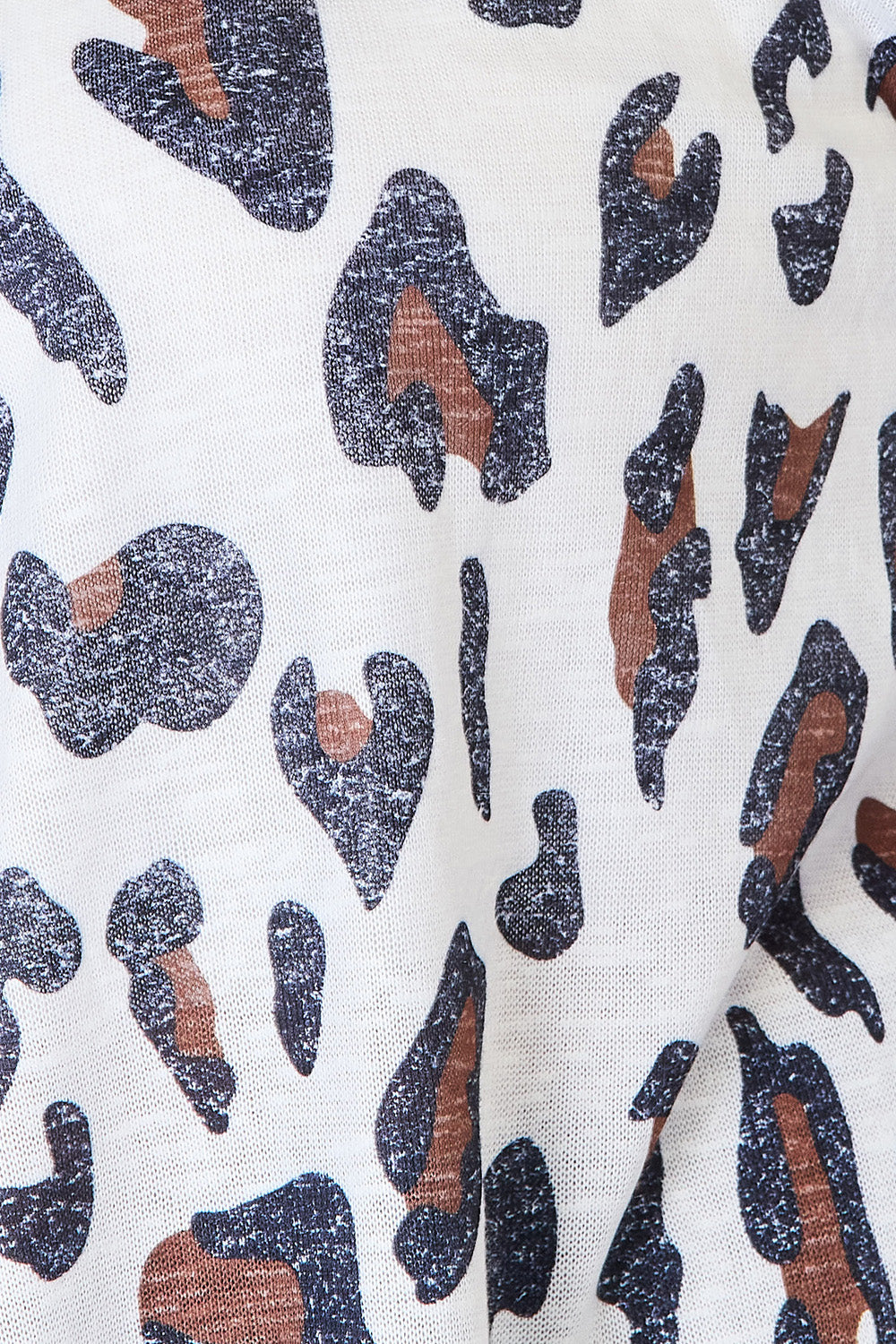 White leopard print long sleeve cardigan by Trendsi, featuring a cozy, stylish design with a front button closure.