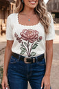 White floral scalloped hem short sleeve knit top from Trendsi, featuring a delicate flower pattern and feminine scalloped edges.