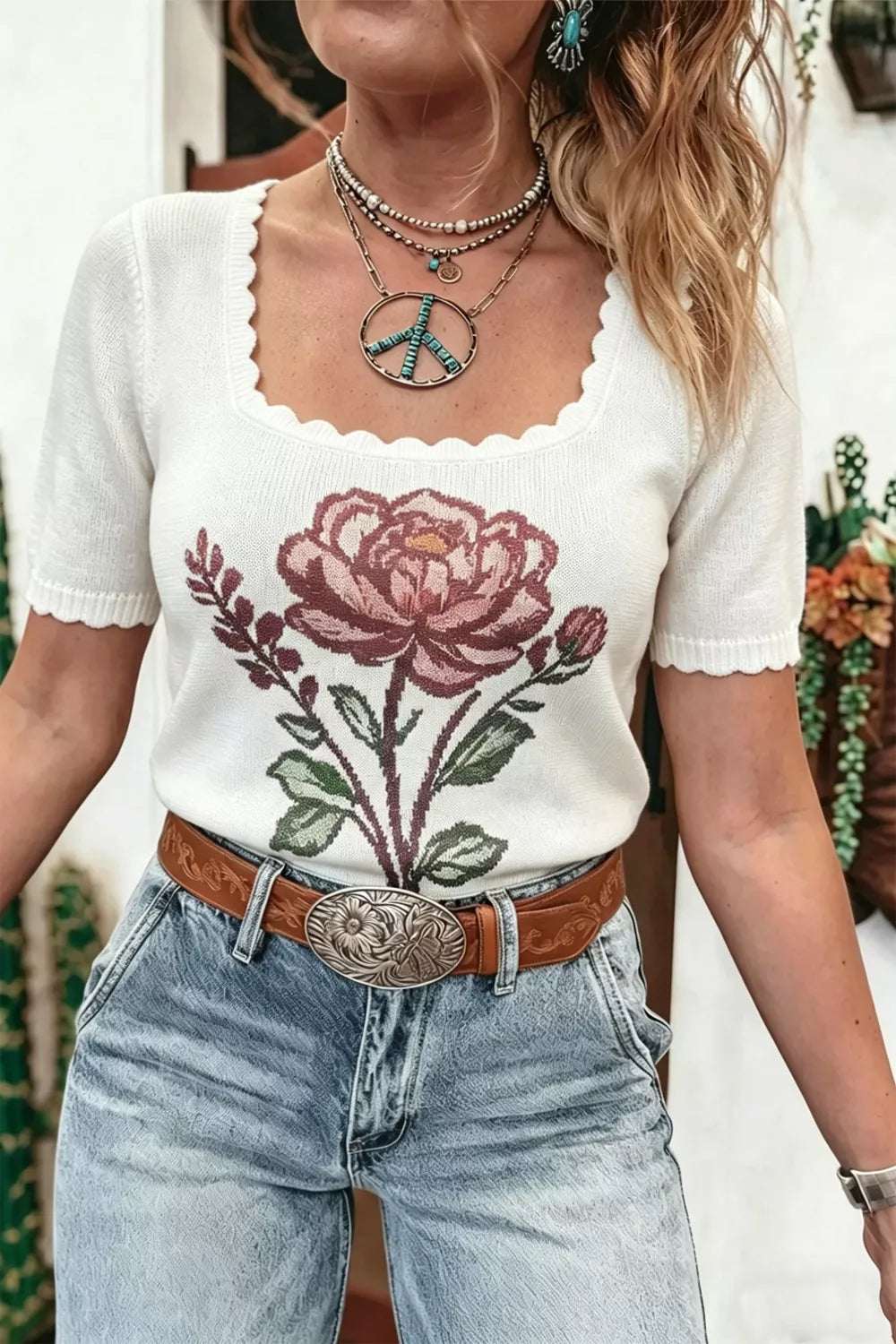 White flower scalloped hem short sleeve knit top by Trendsi, featuring a delicate floral pattern and scalloped neckline.