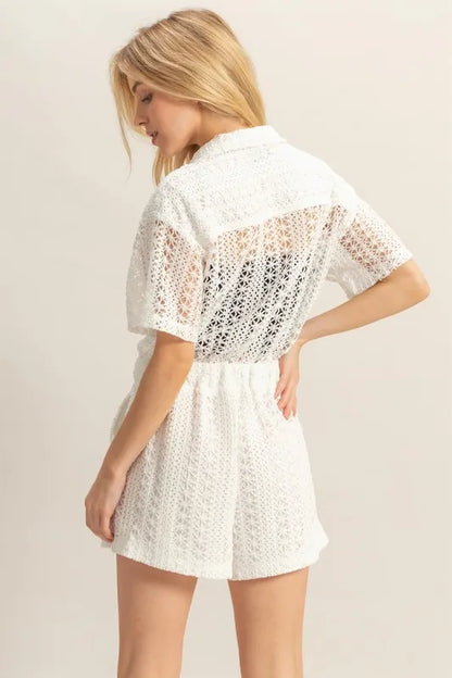 White crochet button-front short sleeve romper by HYFVE, featuring a casual, stylish design with a relaxed fit and front buttons.