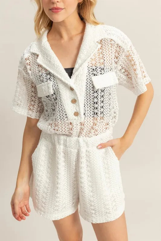 White HYFVE crochet button-front short sleeve romper with a relaxed fit, featuring a V-neck and casual summer style.