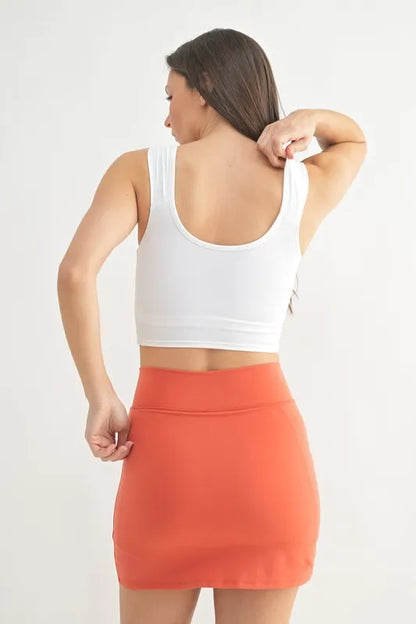 White MONO B ruched front active tank top by Trendsi, featuring a fitted design and sleeveless style for activewear or casual wear.