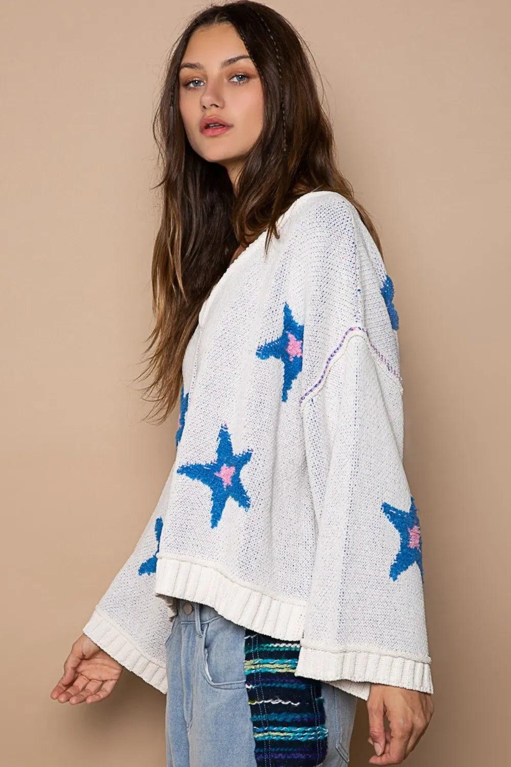 White POL long sleeve star patch sweater from Trendsi featuring a cozy knit fabric and stylish star patch details.
