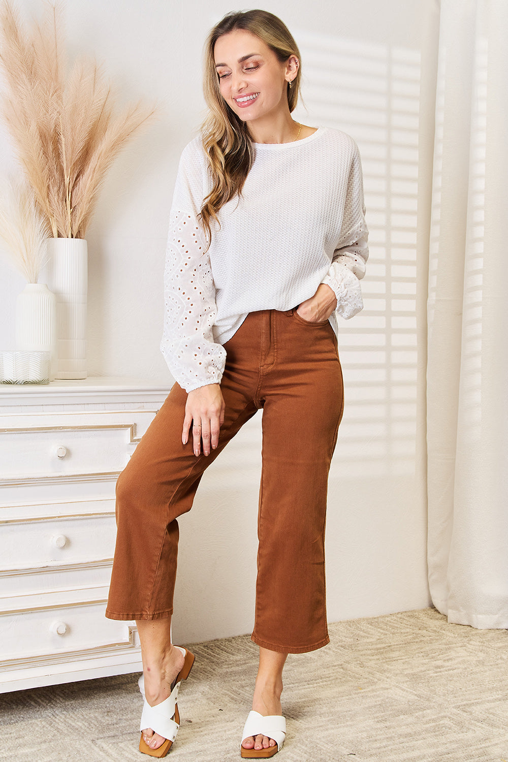 White shiny eyelet dropped shoulder round neck blouse by Trendsi, featuring a stylish design and feminine details.
