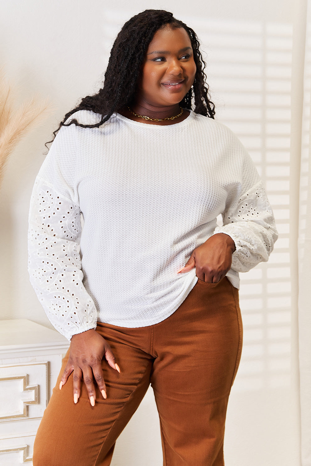 White shiny eyelet blouse with dropped shoulders and round neckline, stylish Trendsi women's top.