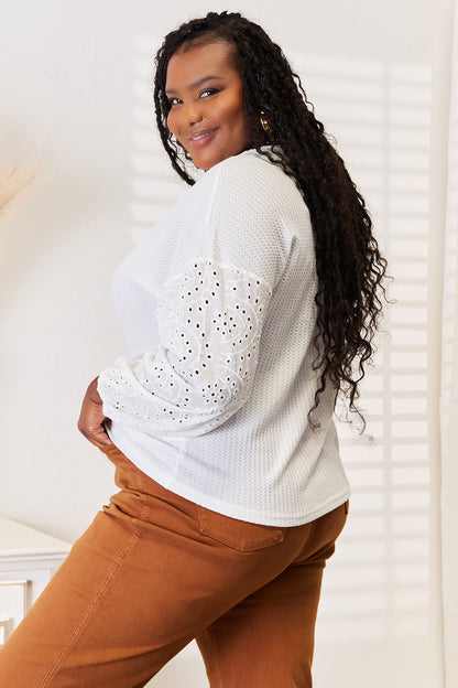 White shiny eyelet dropped shoulder blouse with round neckline from Trendsi, featuring a stylish and feminine design.