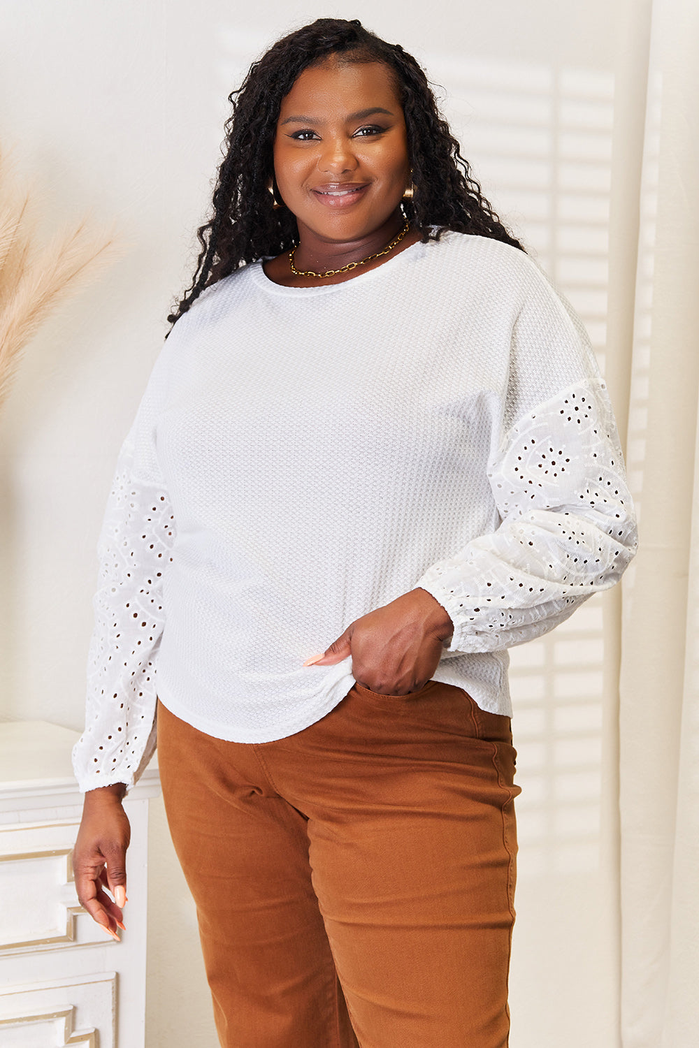 White shiny eyelet blouse with dropped shoulders and a round neckline, featuring a trendy, relaxed fit from Trendsi.