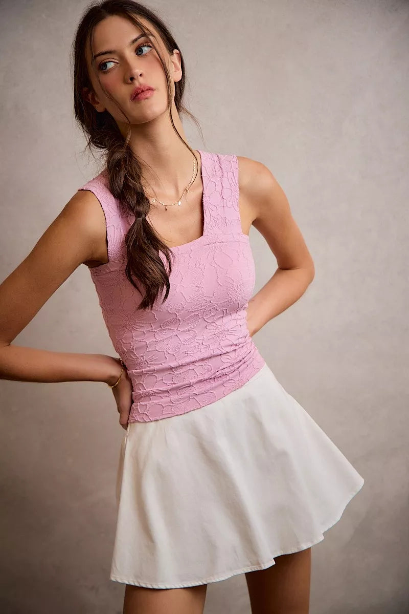 White denim bubble skort with smocked back from SO ME by Trendsi, shown on a model, highlighting its casual, stylish design.