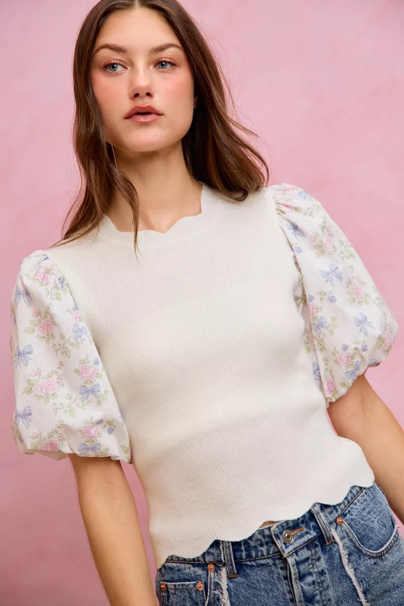 White floral cotton sweater top from Trendsi with contrast sleeves and scallop hem, stylish and comfortable for casual wear.