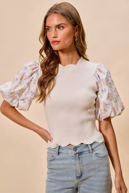 White floral cotton sweater top with contrast sleeves and scalloped hem, trendy and stylish for casual wear.