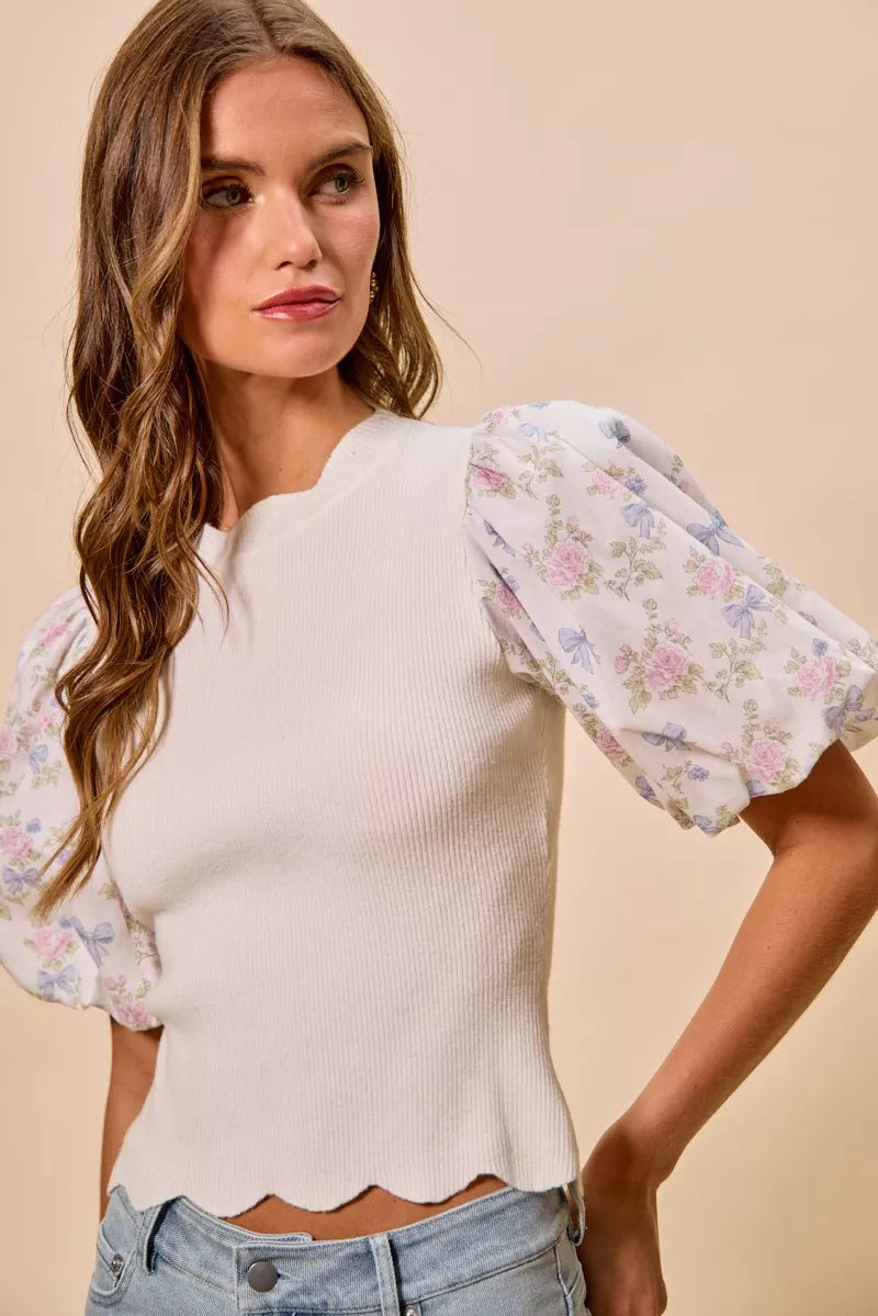 White floral cotton sweater top with contrast sleeves and scalloped hem, trendy and stylish for casual wear.