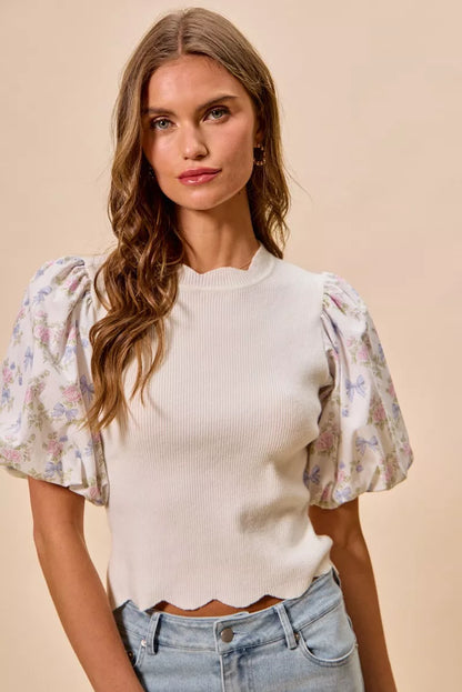 White floral cotton sweater top with contrast sleeves and scalloped hem from Trendsi, featuring a stylish and comfortable design.