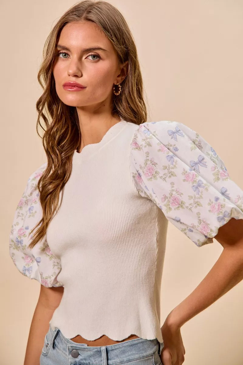White floral cotton sweater top with contrast sleeves and scalloped hem from Trendsi, featuring a stylish, feminine design.