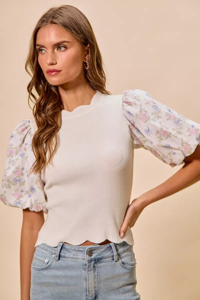 White floral cotton sweater top with contrast sleeves and scalloped hem, by Trendsi, shown on a model.