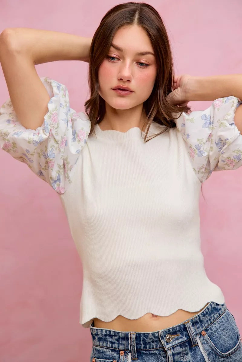 White floral cotton sweater top with contrasting scalloped sleeves from Trendsi, featuring a stylish and feminine design.