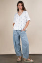 White Very J Flower embroidered woven blouse by Trendsi, featuring intricate floral embroidery and lightweight fabric.