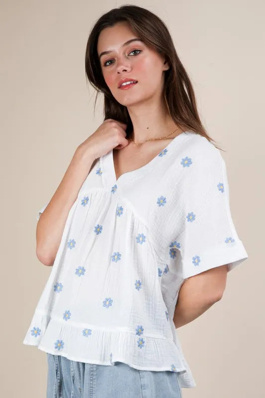 White woven blouse from Trendsi with embroidered J flower design, featuring long sleeves and a relaxed fit.