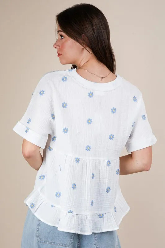 White woven blouse from VERY J with embroidered flower details, featuring a relaxed fit and stylish design by Trendsi.