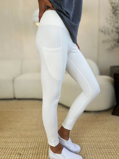 White Trendsi wide waistband sports leggings displayed on a model, showcasing a comfortable fit and athletic style.