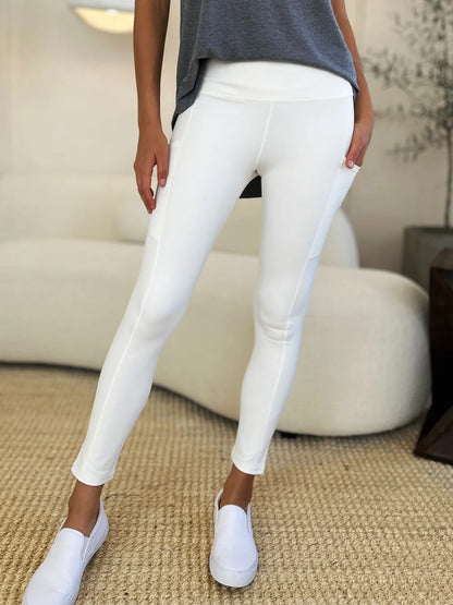 White wide waistband sports leggings by Trendsi, made of stretchy fabric, designed for active wear and comfortable workouts.