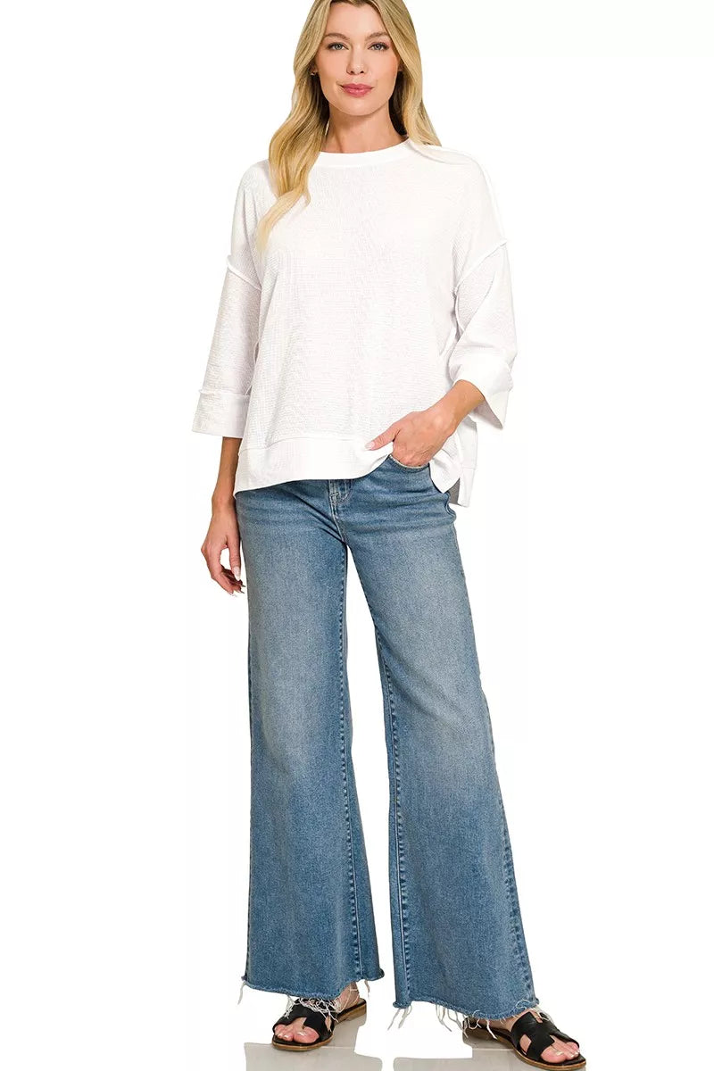 White Zenana double knit 3/4 sleeve top with a relaxed fit, showcased on a mannequin, ideal for casual or office wear.