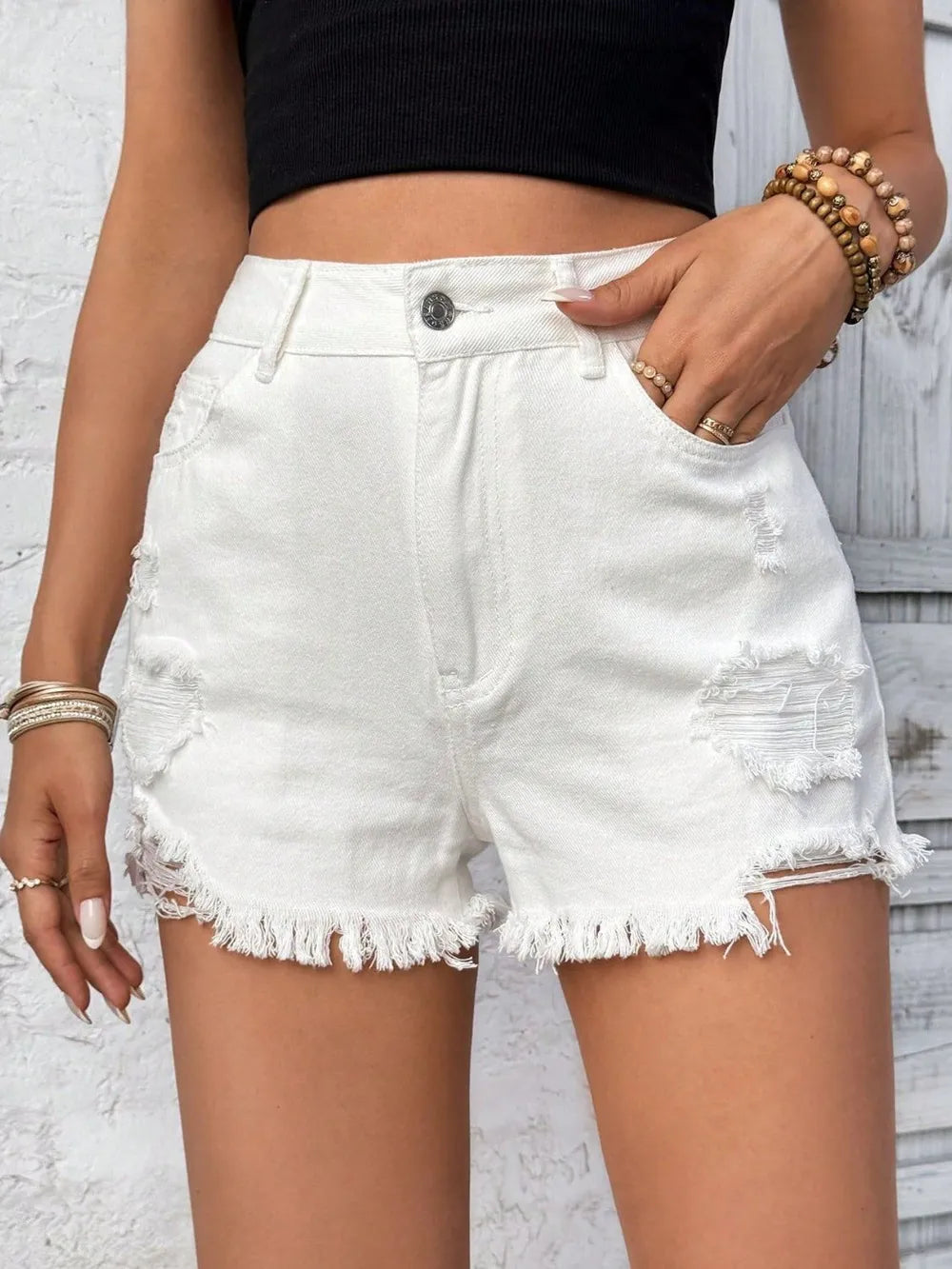 White distressed raw hem high-rise denim shorts from Trendsi, featuring a fitted waist and casual, worn-in style.