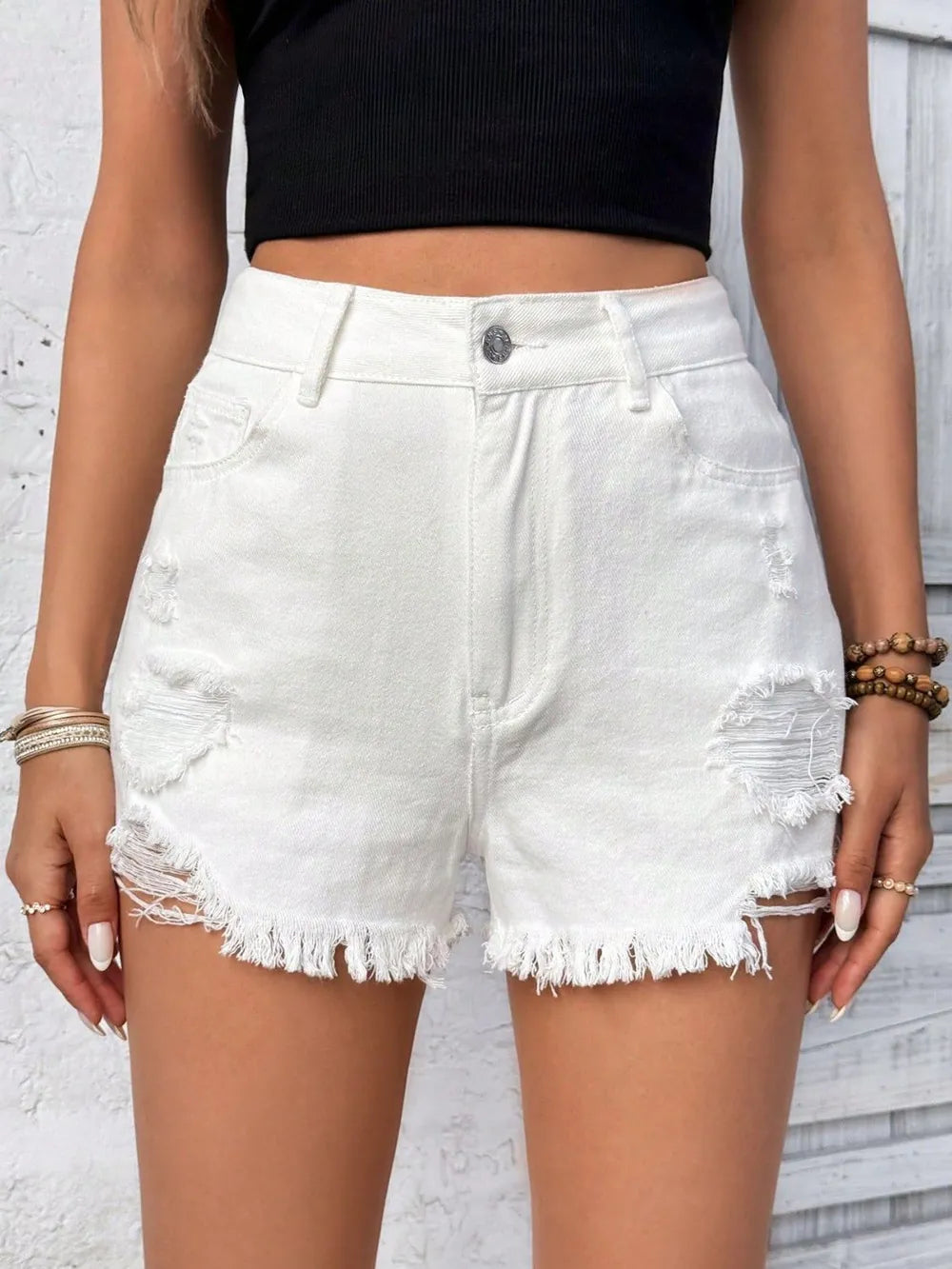 White distressed raw hem high-rise denim shorts by Trendsi, featuring a casual fit and frayed edges, perfect for summer wear.