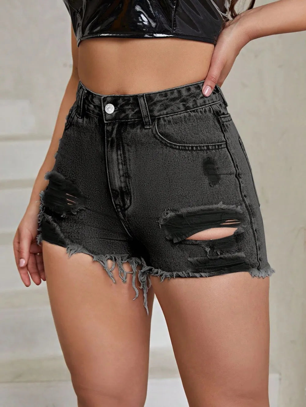 White distressed raw hem high-rise denim shorts from Trendsi, showcasing a trendy casual fit with frayed edges and a high waist.