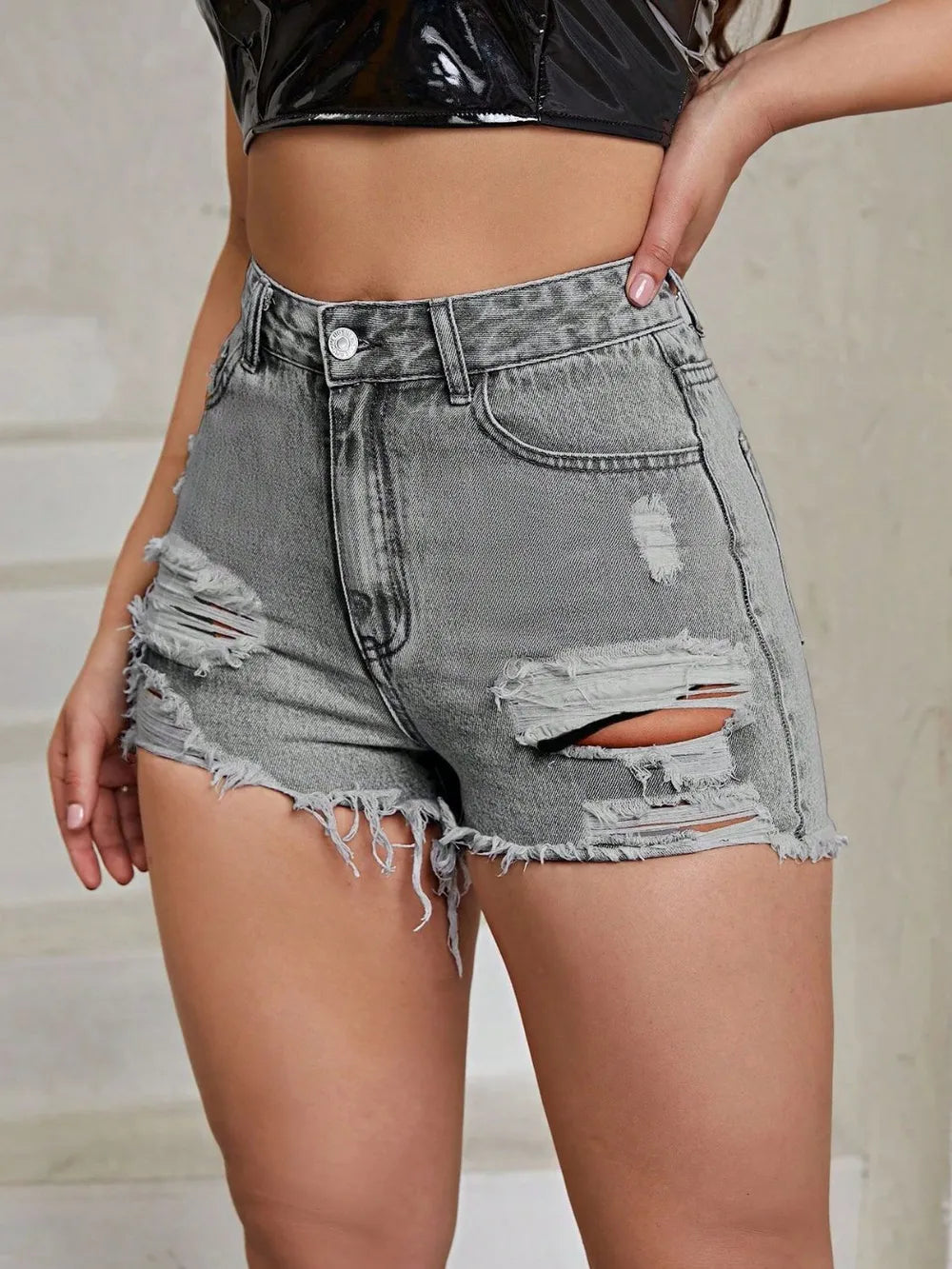 White distressed raw hem high-rise denim shorts from Trendsi, featuring a casual fit and frayed edges, perfect for summer wear.