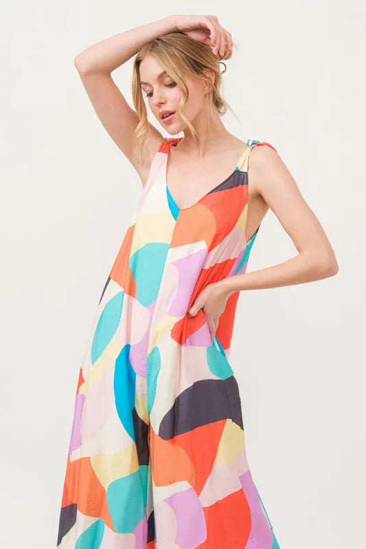 Yellow multi-colored geo print jumpsuit with tied shoulder straps and wide-leg design from Trendsi.