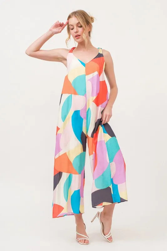 Yellow multi-colored geo print jumpsuit with tied shoulder straps and wide-leg design from Trendsi.