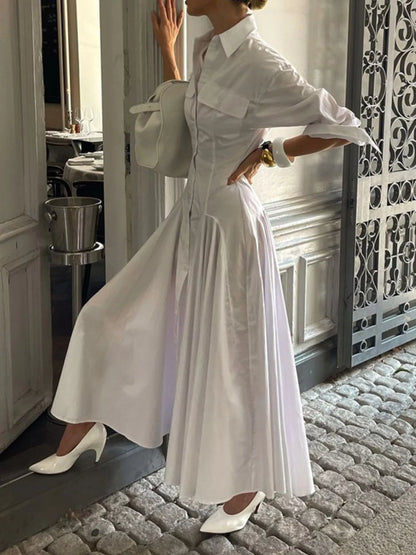 White button-front long sleeve maxi shirt dress by Trendsi, featuring a relaxed fit and classic collar, styled for casual wear.