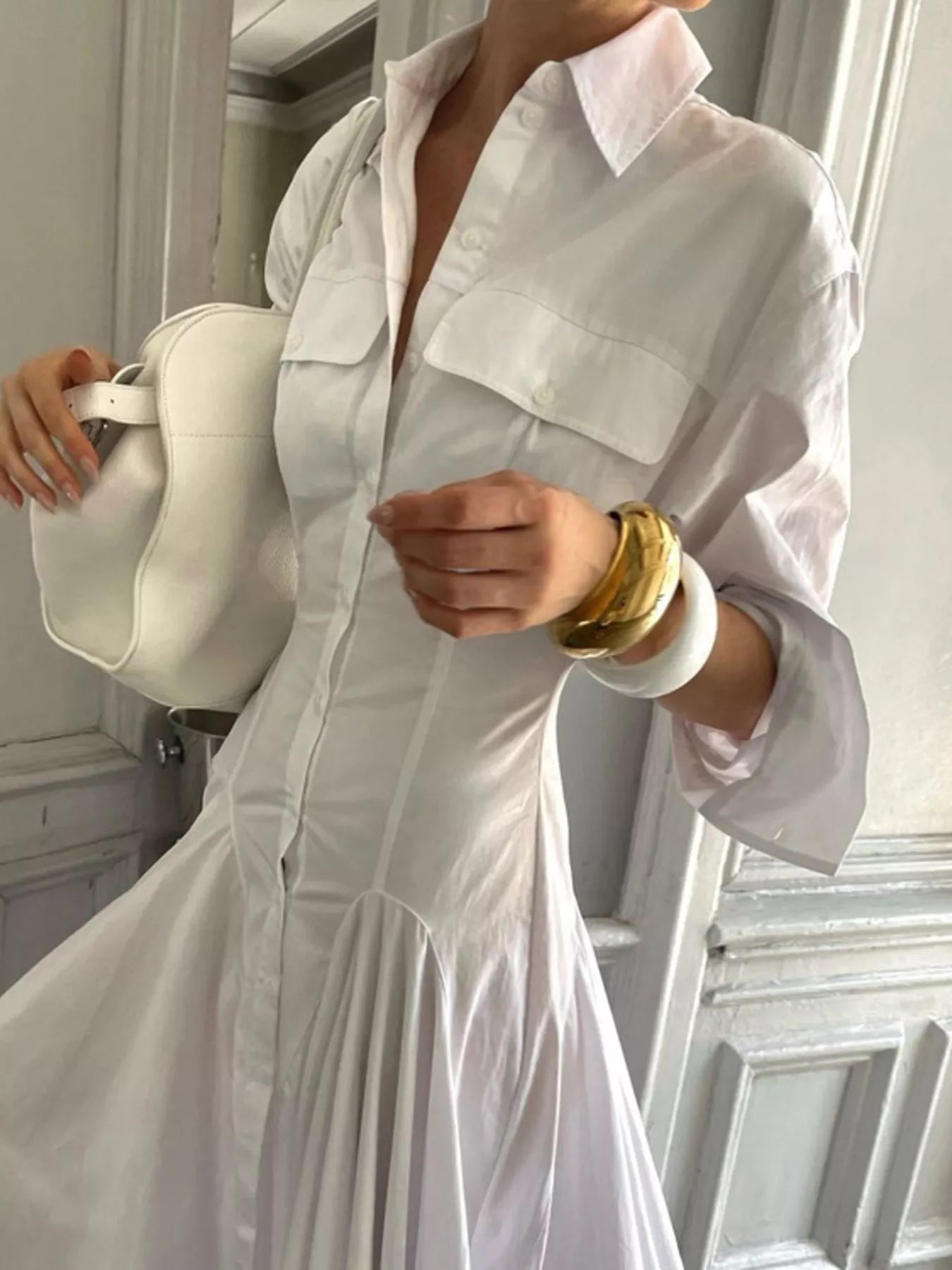 White button-front long sleeve maxi shirt dress by Trendsi, featuring a relaxed fit and classic collar, perfect for casual wear.