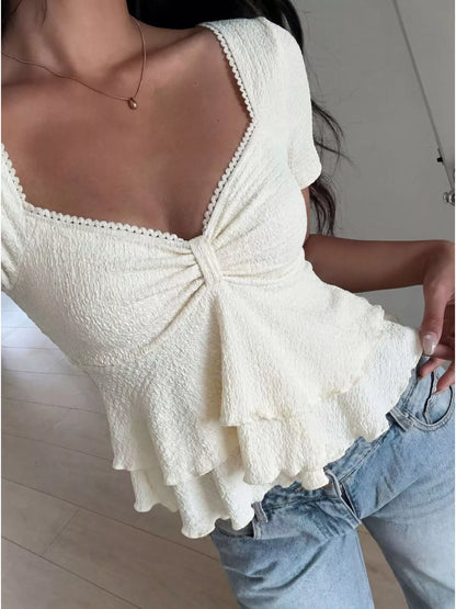 White sweetheart neckline layered ruffle top from Trendsi, featuring a feminine design and ruffle details.